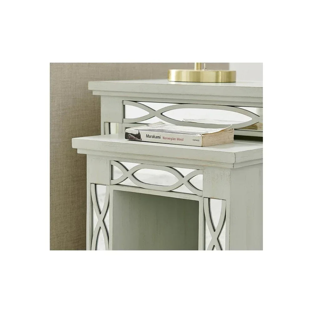 Mirrored bedside table with geometric detailing and book on white tabletop