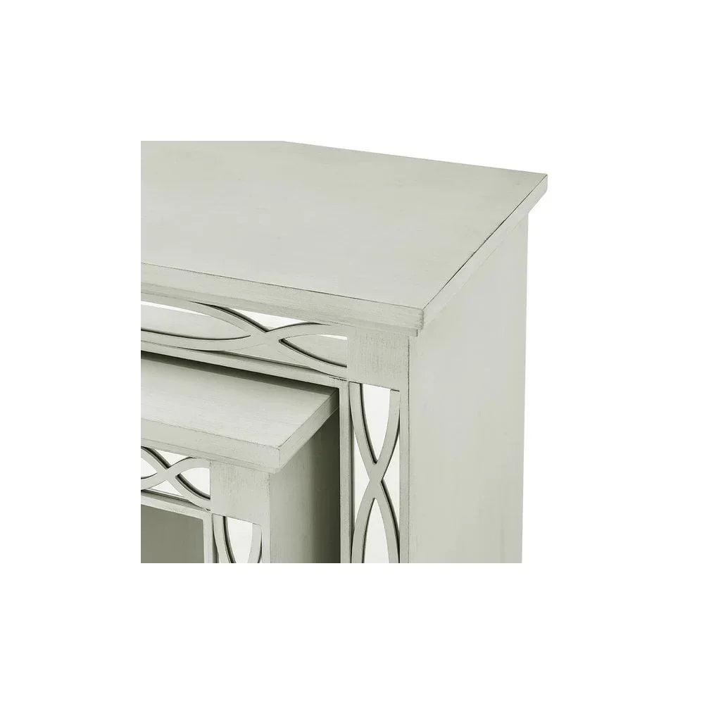 Silver nesting tables with mirrored geometric side detail, close-up corner view