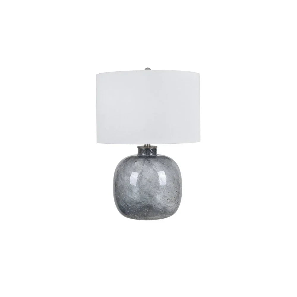 Grey ceramic table lamp with round base and white drum lampshade