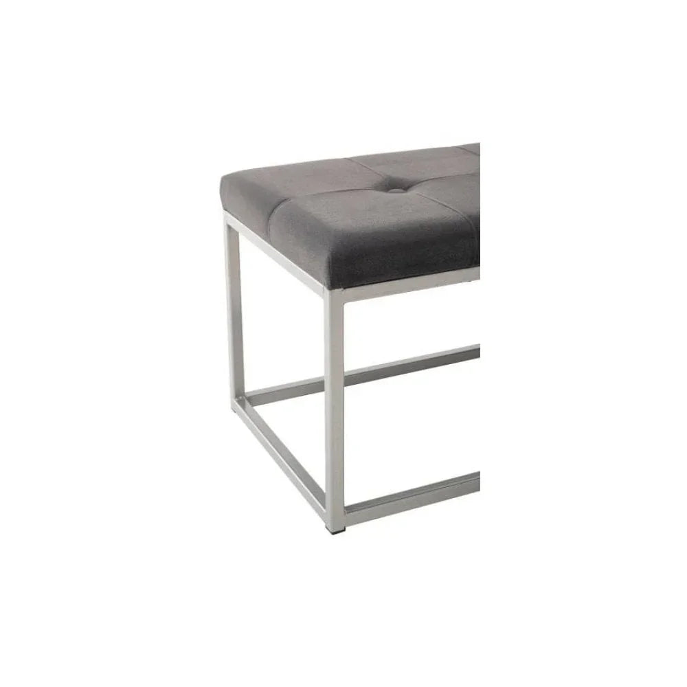 Grey upholstered bench seat with metal frame and tufted cushion, modern corner view