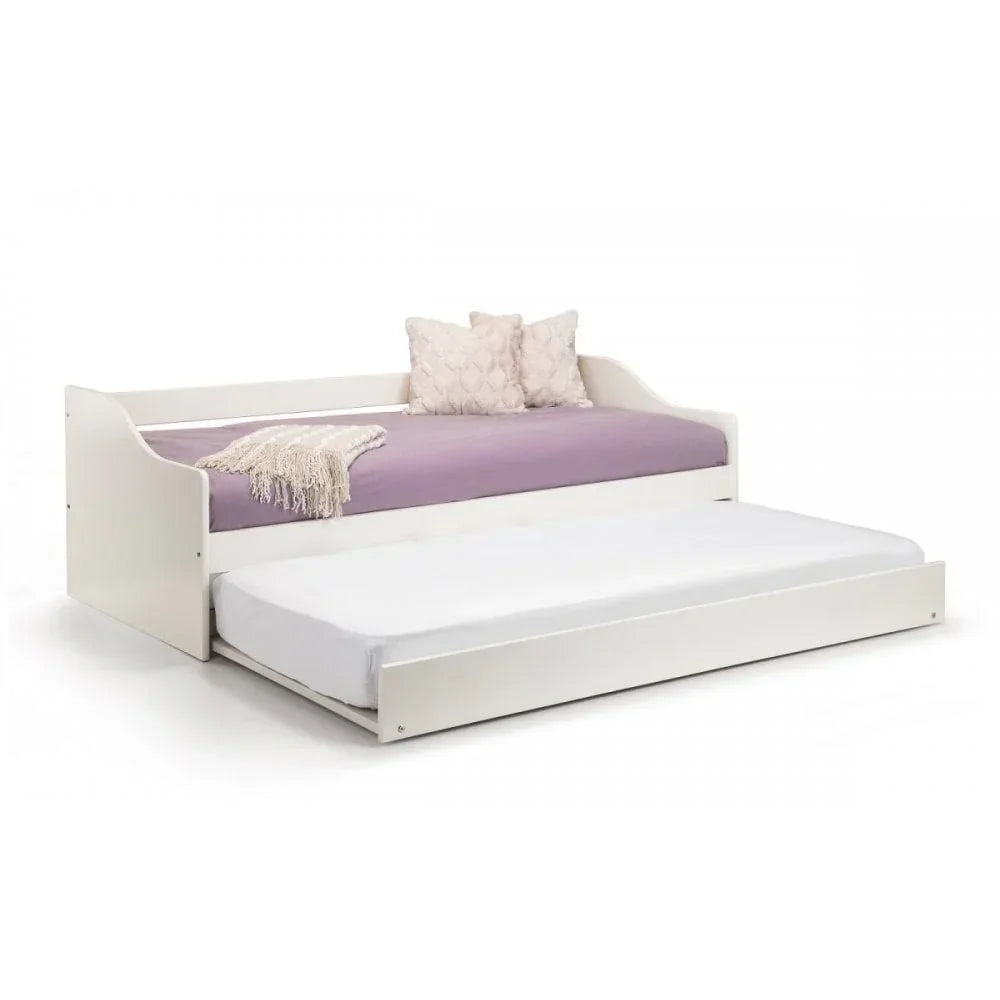 White wooden trundle bed with lavender mattress, throw blanket, and two textured pillows