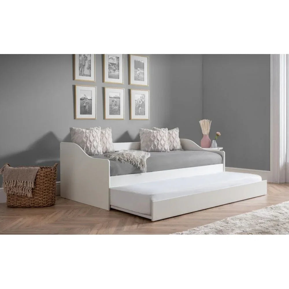 White wooden day bed with pull-out trundle in modern bedroom with grey walls