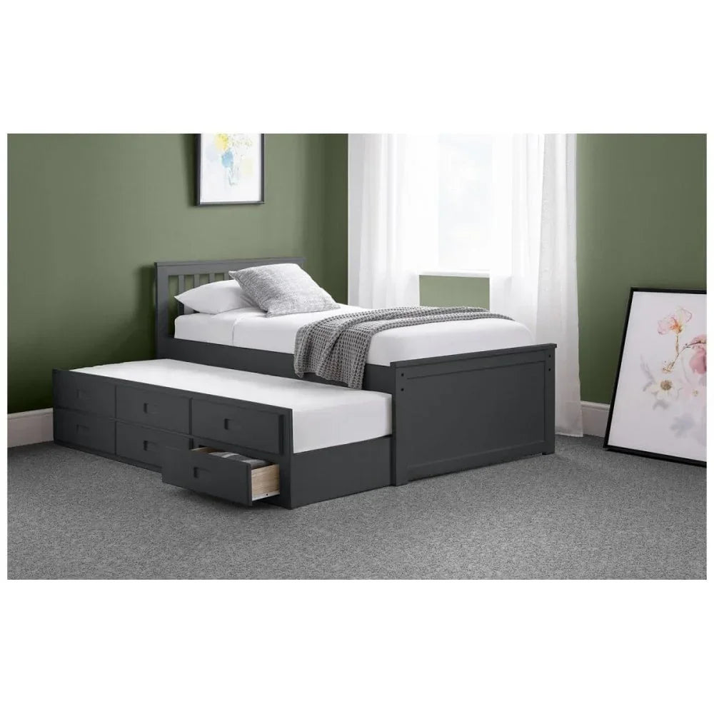 Grey wooden single bed with pull-out trundle and storage drawers in modern bedroom