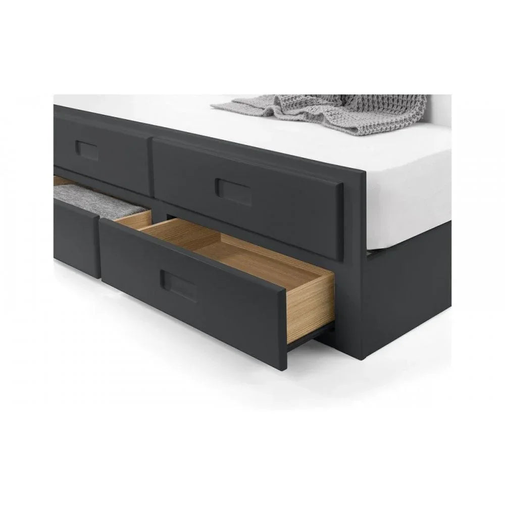 Grey storage bed frame with two open underbed drawers and folded blanket on mattress