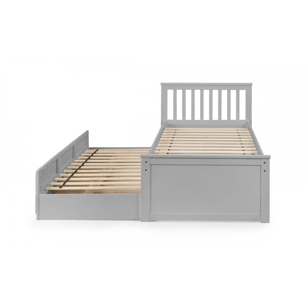 Grey wooden guest bed with pull-out trundle, slatted base, and vertical panel headboard