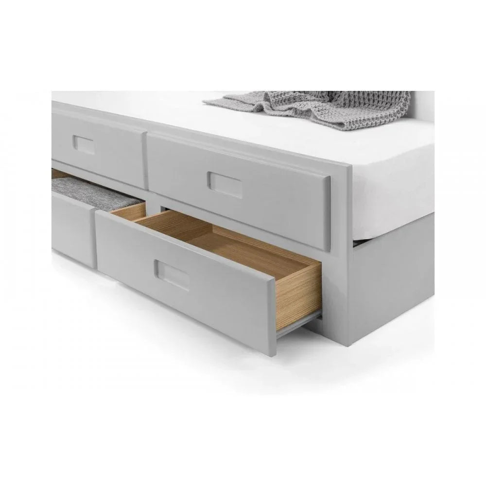 Grey storage bed with three open drawers showing wood interiors and bedding