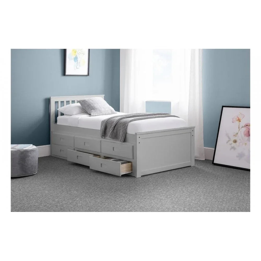 White wooden storage bed with side drawers in a blue painted bedroom