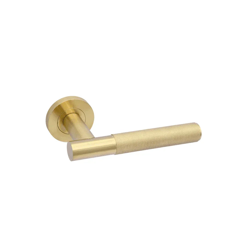 Brass door handle with round backplate and textured lever, modern hardware design