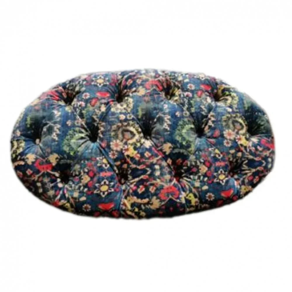 Oval floral ottoman with deep blue pattern and tufted upholstery