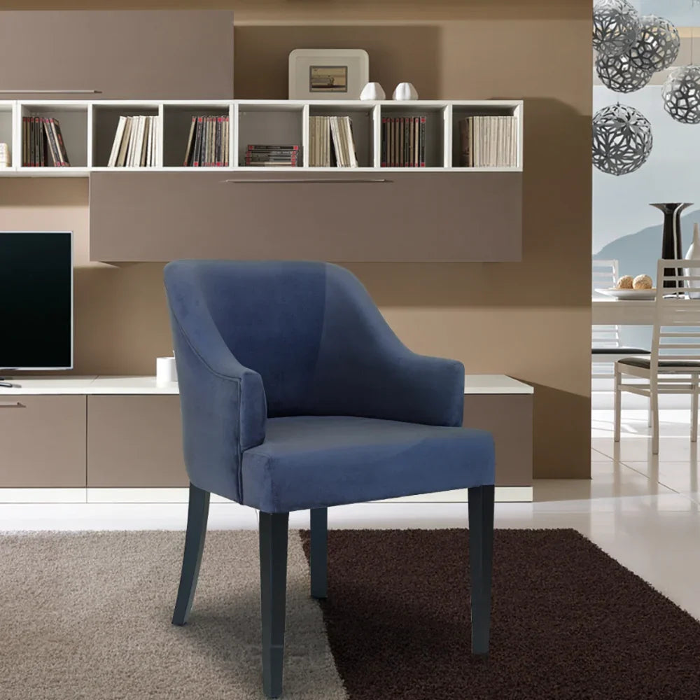 Grey fabric accent chair with curved arms on rug in modern living room setting