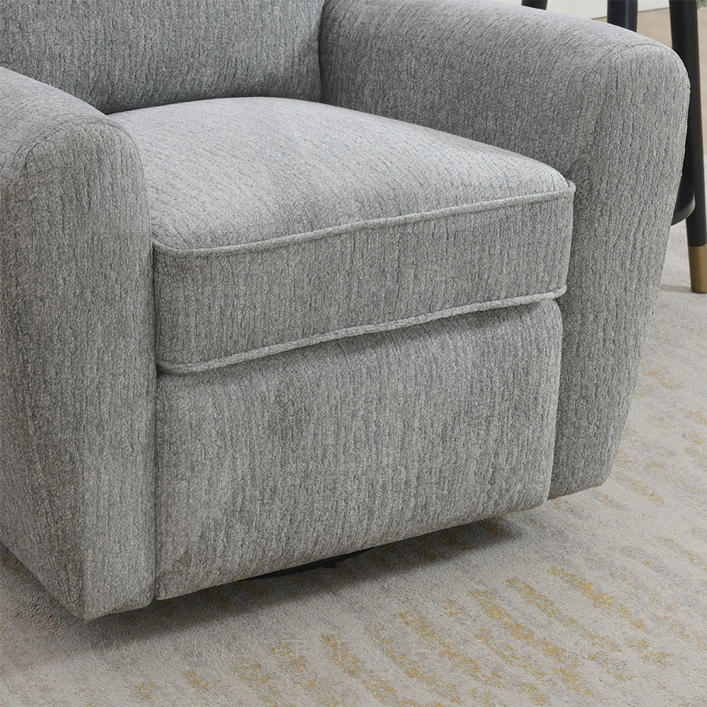 Grey swivel chair with soft textured fabric and padded seat on light patterned rug