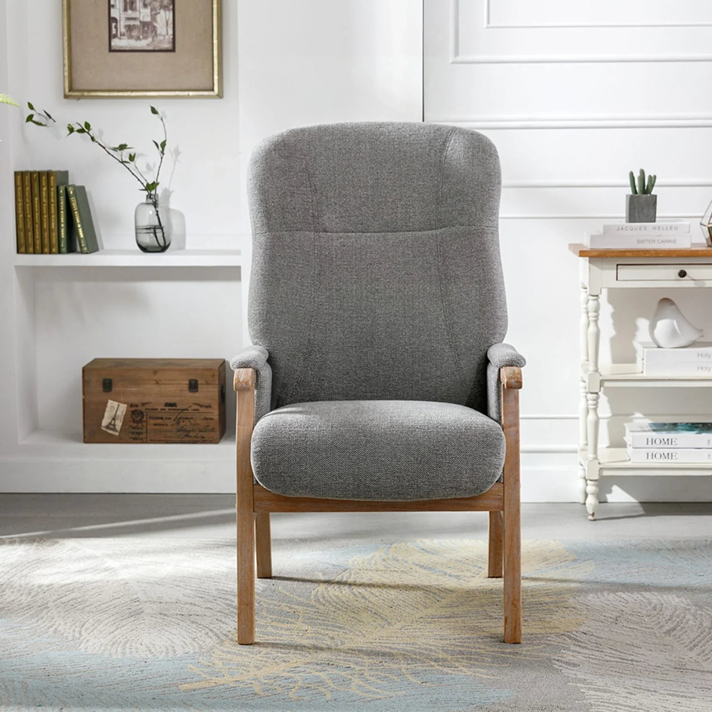 Grey fabric armchair with wooden legs in a modern living room setting
