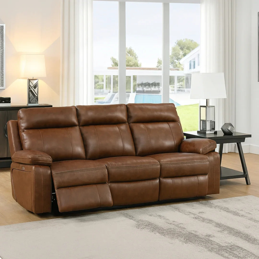 Brown leather three-seater recliner sofa in modern living room with side tables and lamps