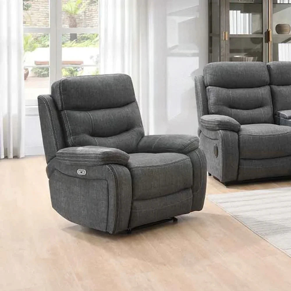 Dark grey fabric recliner armchair with matching piping in modern living room setting