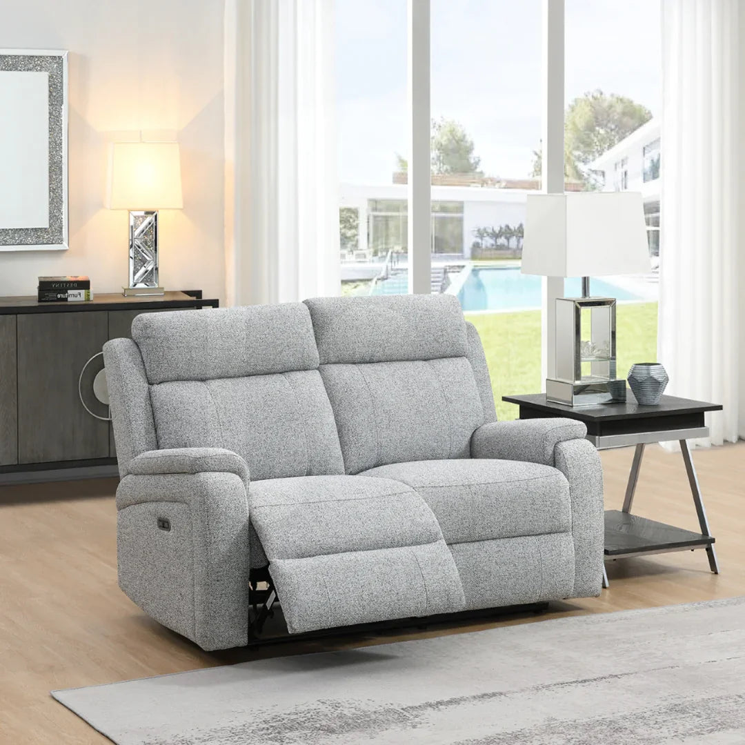 Silver fabric loveseat recliner with padded arms in bright modern living room