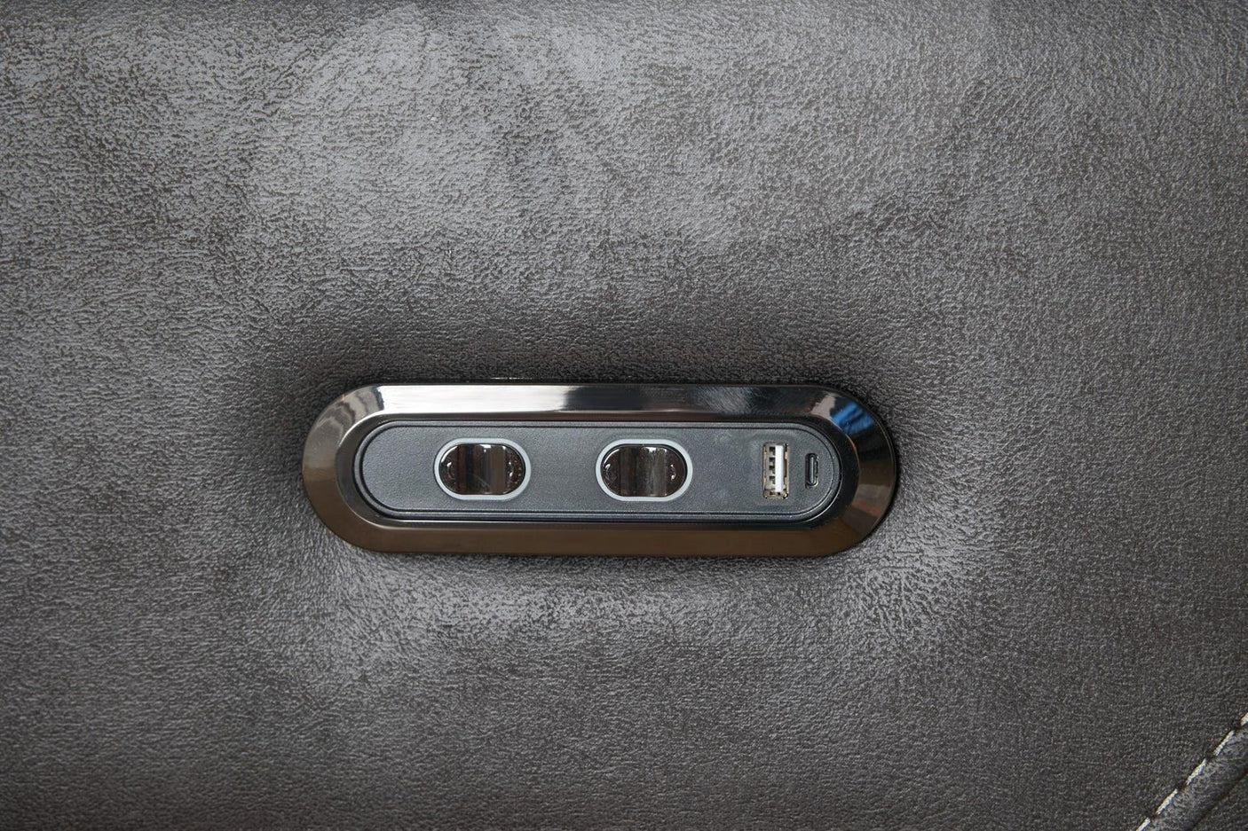 Grey sectional sofa control panel with USB port and buttons on fabric armrest