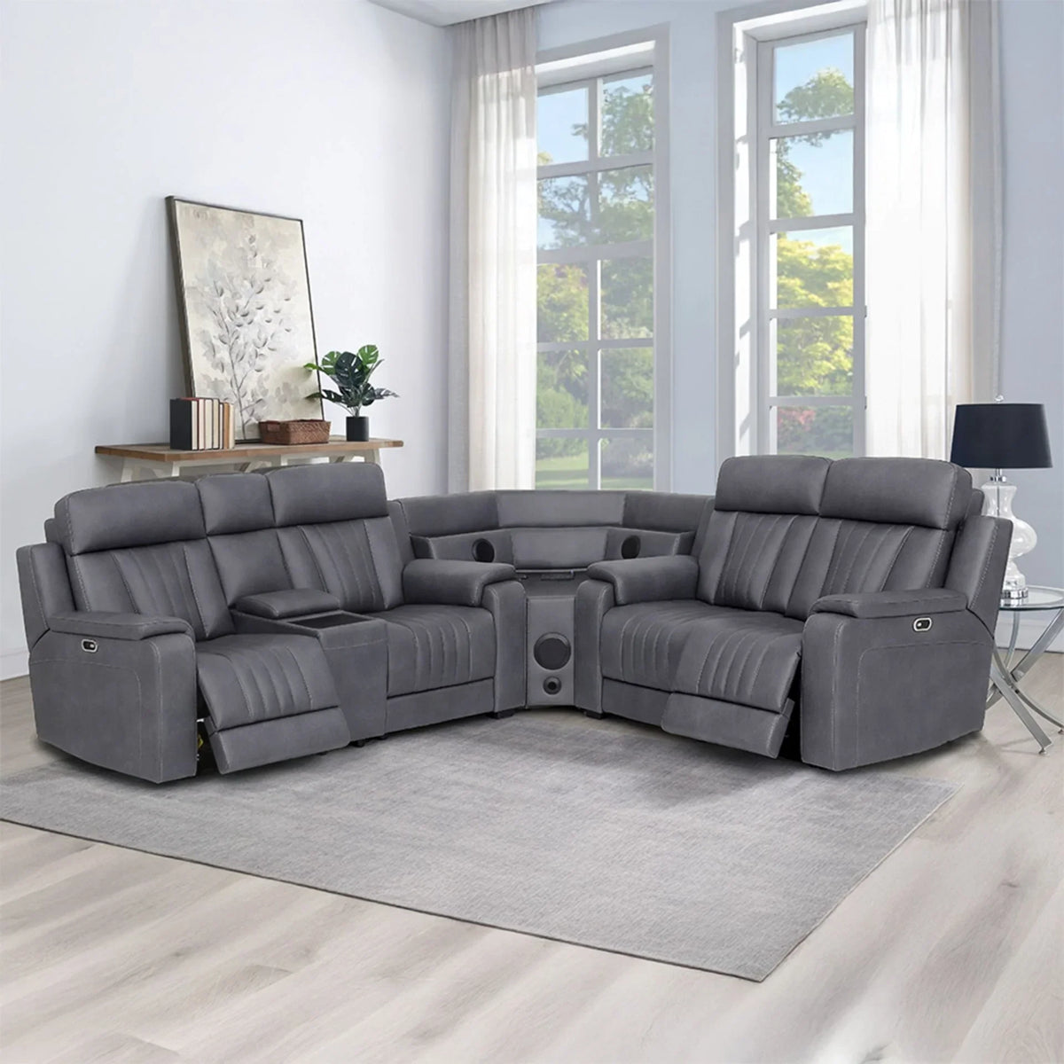 Grey sectional sofa with recliners and cup holders in a bright living room