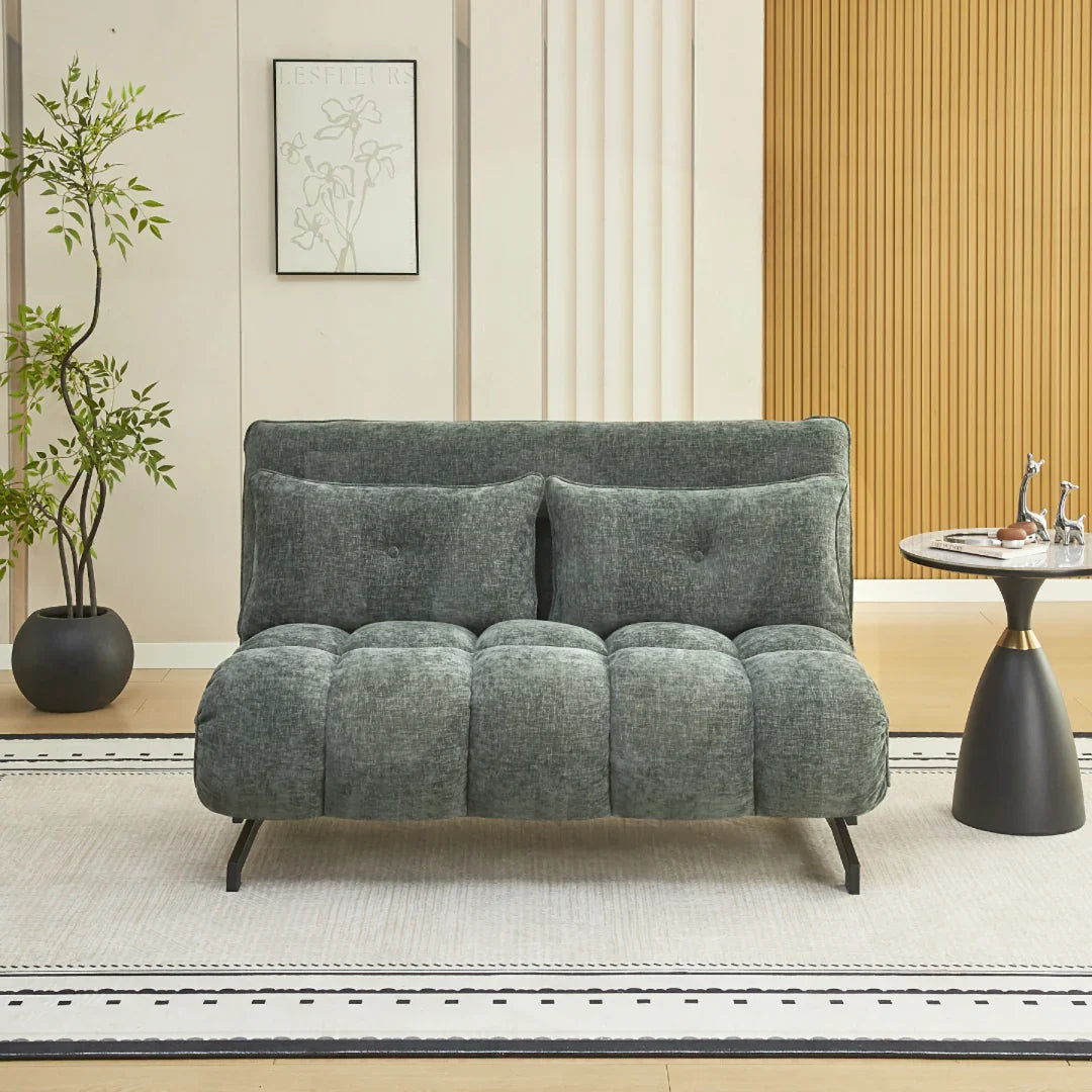 Double sofa bed in winter moss fabric with tufted seat and cushions, shown in a modern room