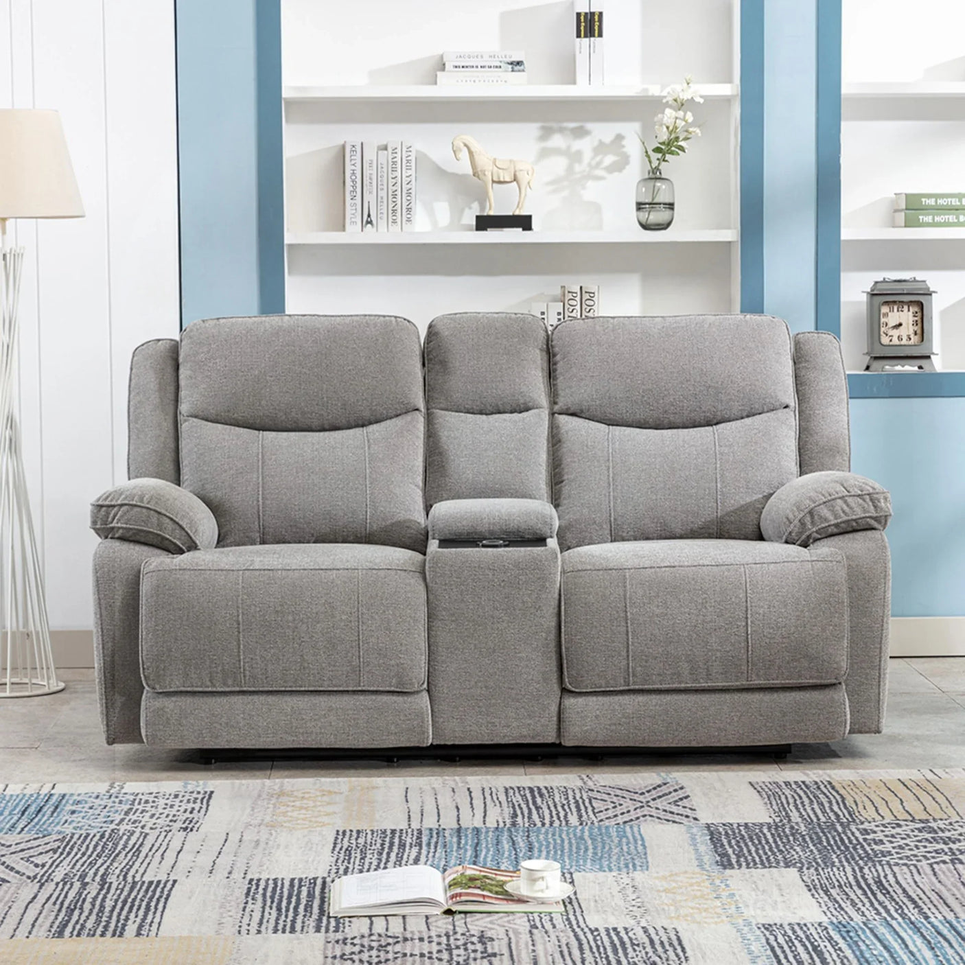 Light grey electric recliner sofa with central console and wireless charger in modern living room