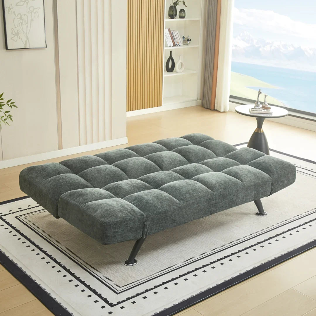 Winter moss fabric sofa bed opened flat on patterned rug in modern living room