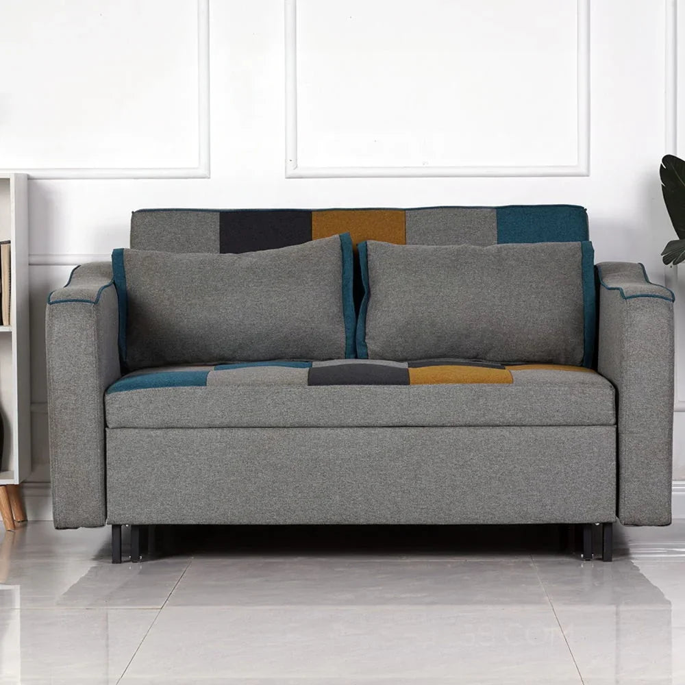 Grey patchwork fabric sofa with blue and yellow accents, straight armrests, and cushions