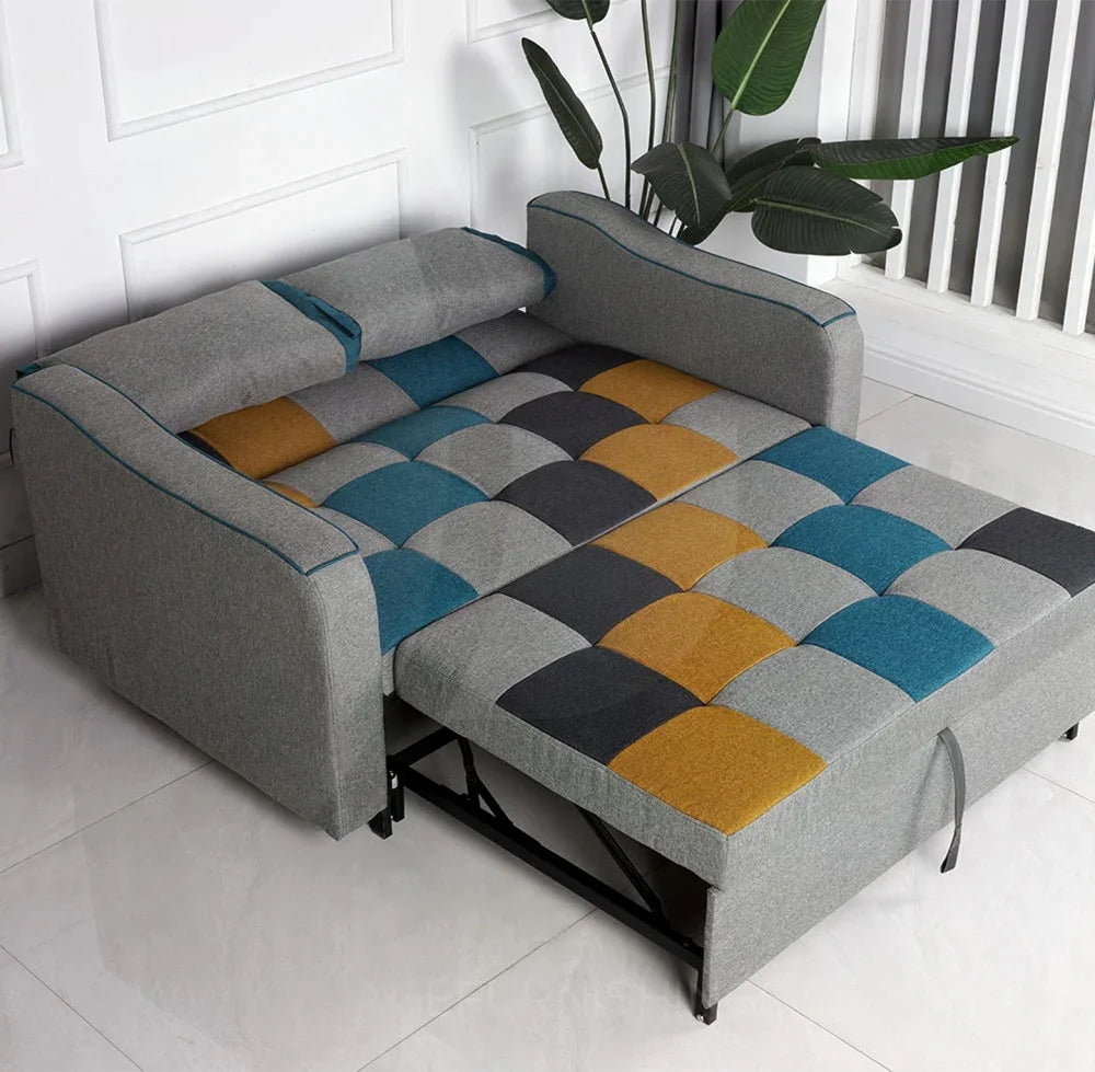 Patchwork sofa bed with yellow, blue, grey upholstery and pull-out sleeping area