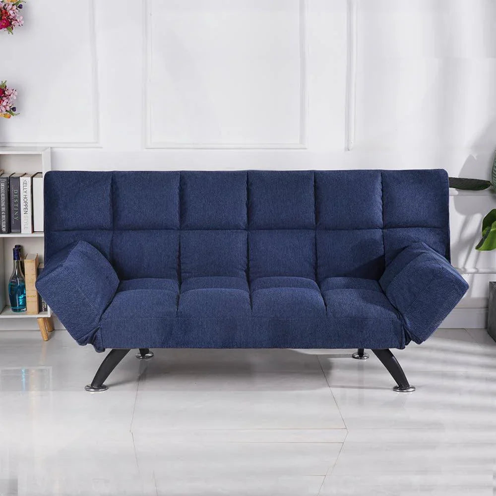 Denim blue sofa bed with tufted upholstery and angled arms in modern living room