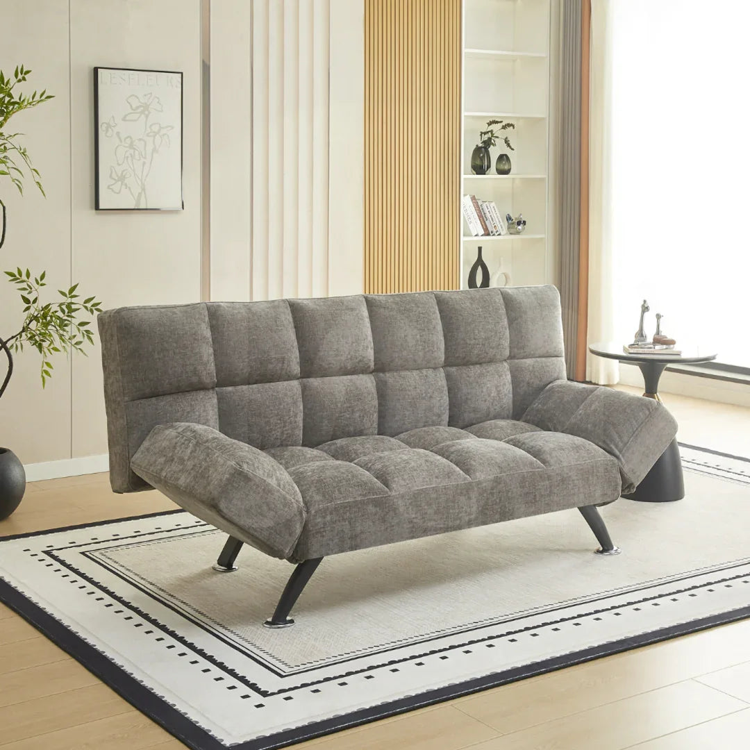 Grey fabric sofa bed with adjustable arms on a patterned rug in modern living room