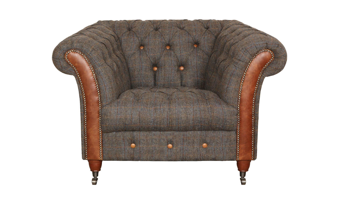 Brown tweed armchair with button-tufted back, leather trim, and wooden legs on castors