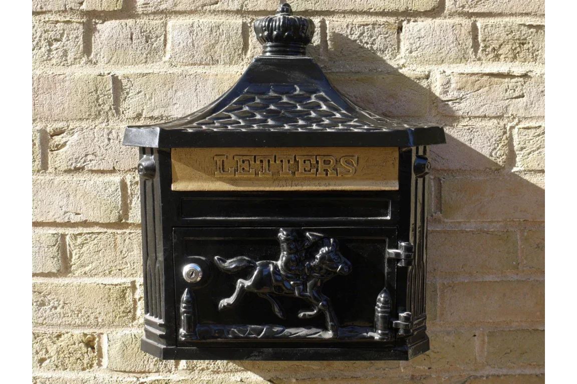 Black wall-mounted post box with gold letters slot and horse rider motif