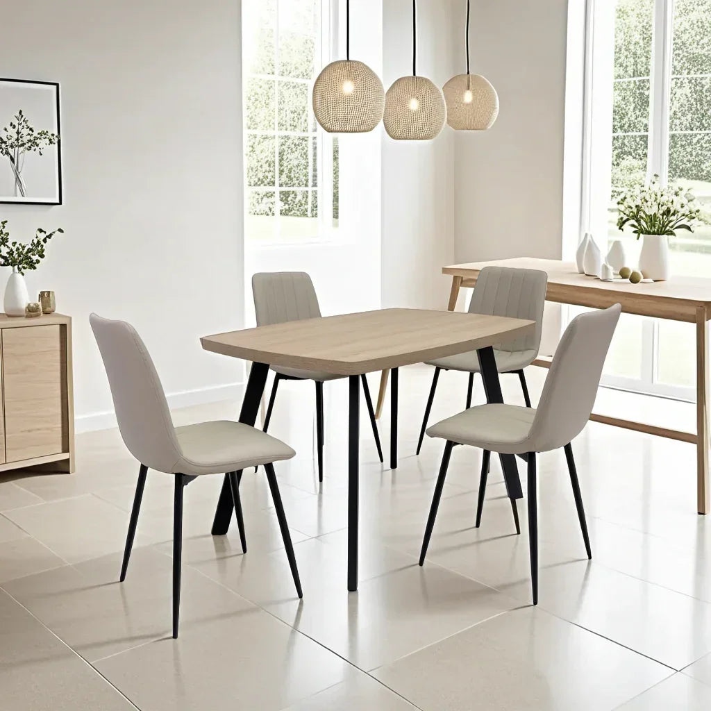 Modern dining table set with four cream chairs and black legs in bright dining room