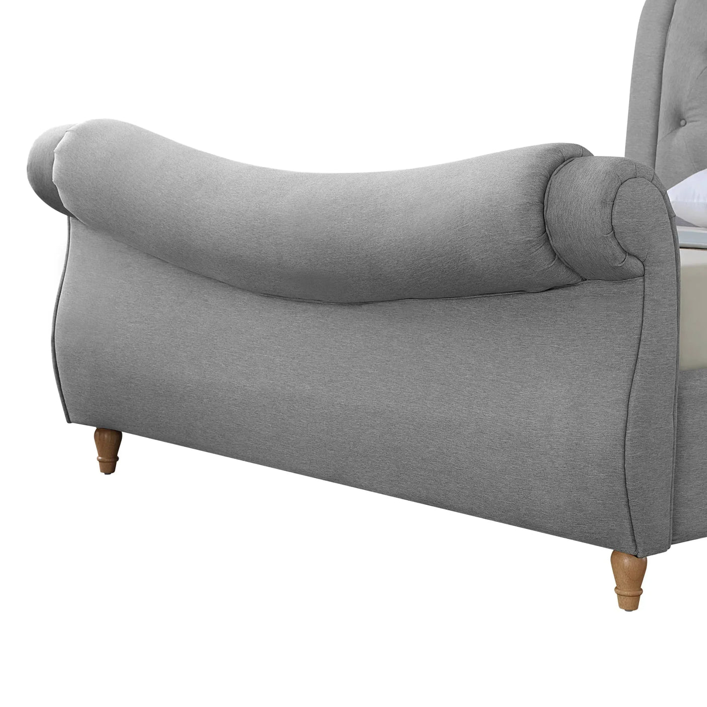 Grey fabric sleigh bed footboard with scroll design and wooden legs