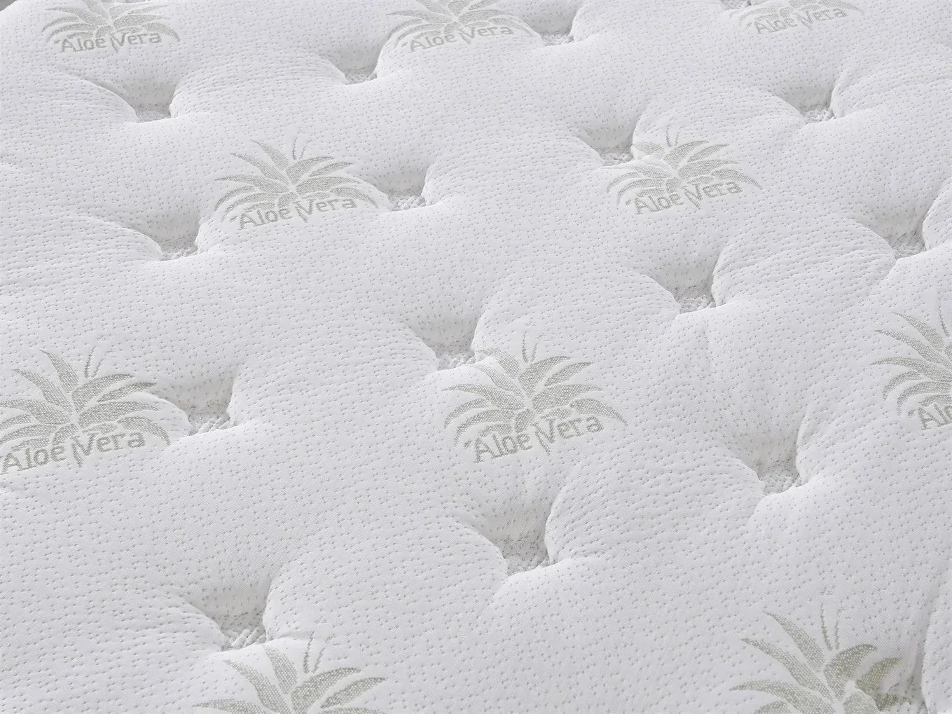 Closeup of aloe vera mattress surface with soft quilted texture and subtle leaf pattern