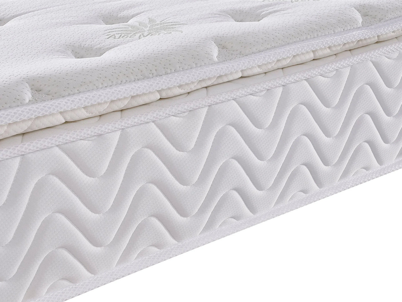 White mattress with quilted top layer and wavy stitch side detail, close up view