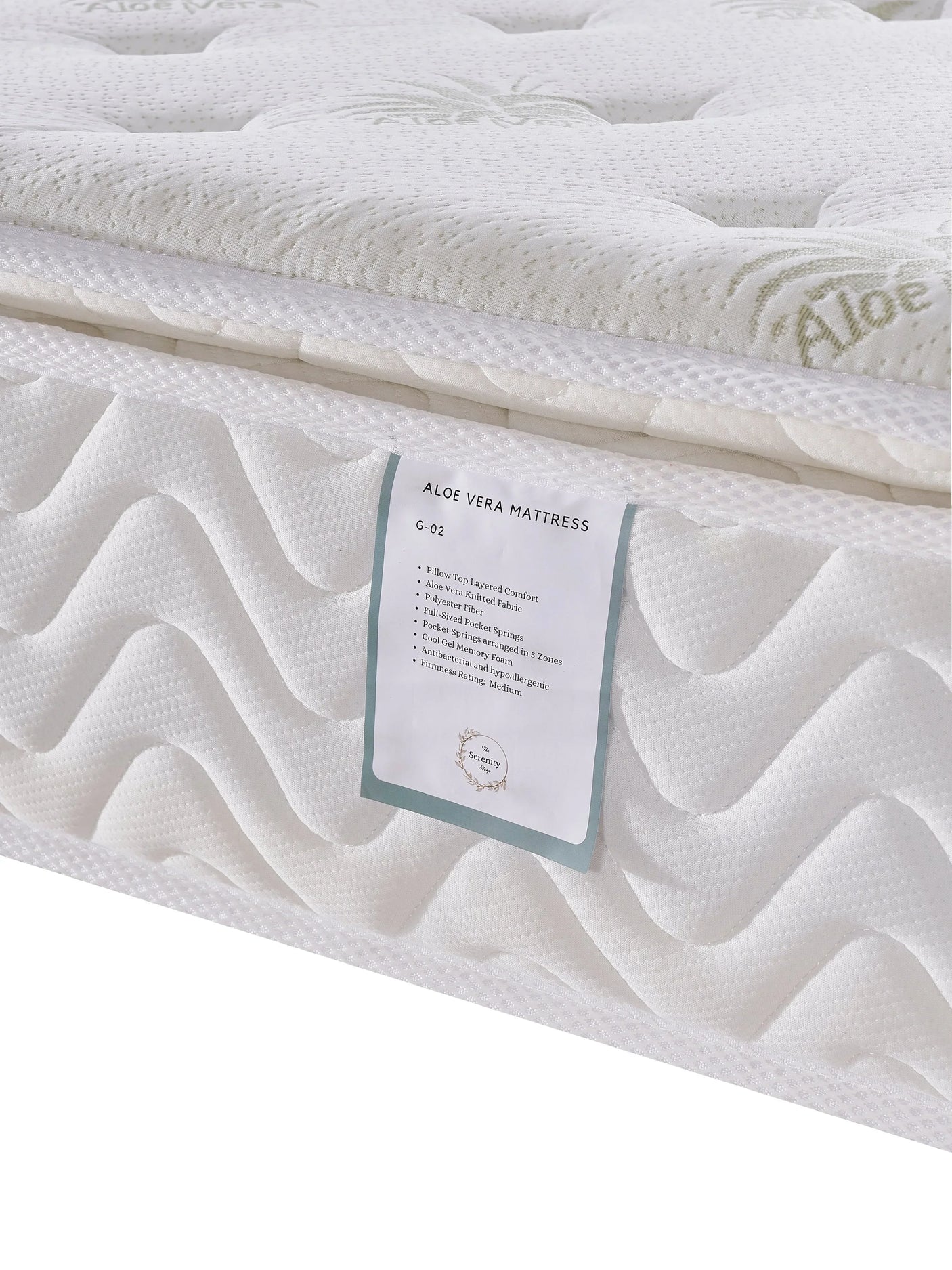 Aloe vera mattress with white quilted surface and product label detail close-up