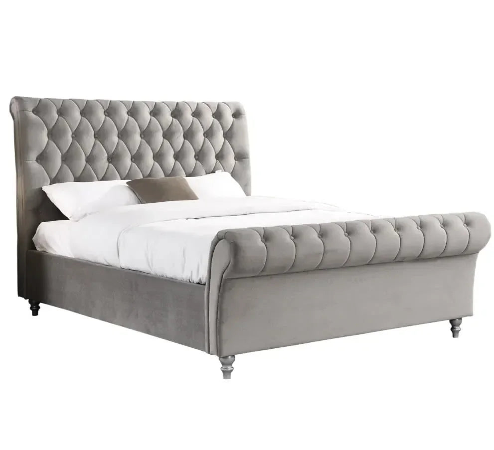 Grey upholstered bed frame with button-tufted headboard and footboard, side angle view