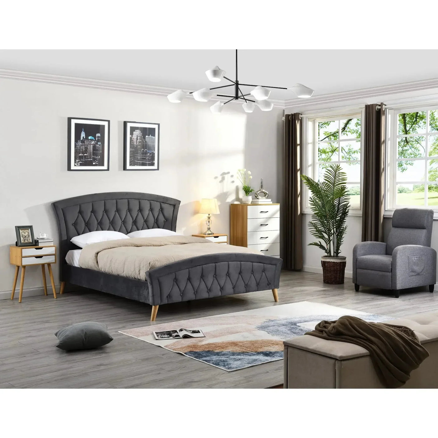 Grey upholstered bed with button detail in modern bedroom, wood nightstands, armchair nearby