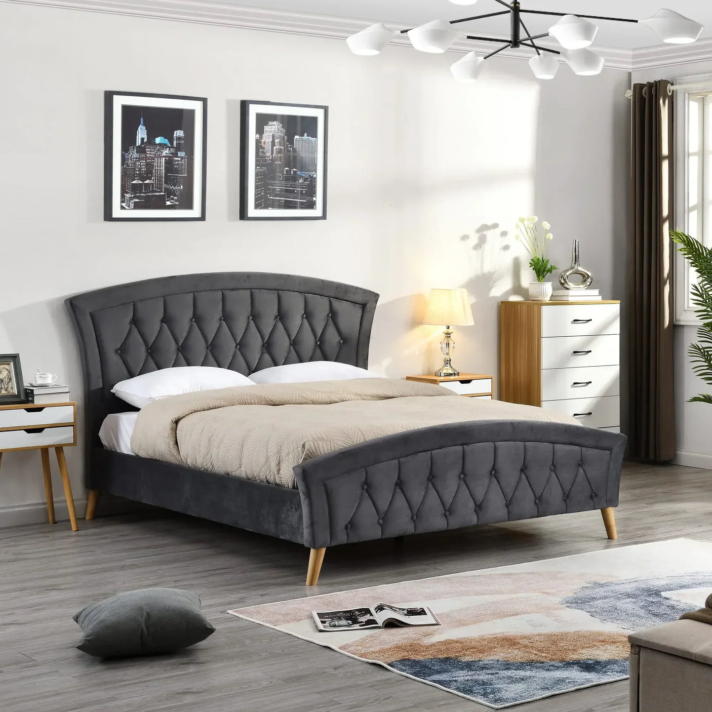 Grey velvet upholstered bed frame with wooden legs in modern bedroom setting
