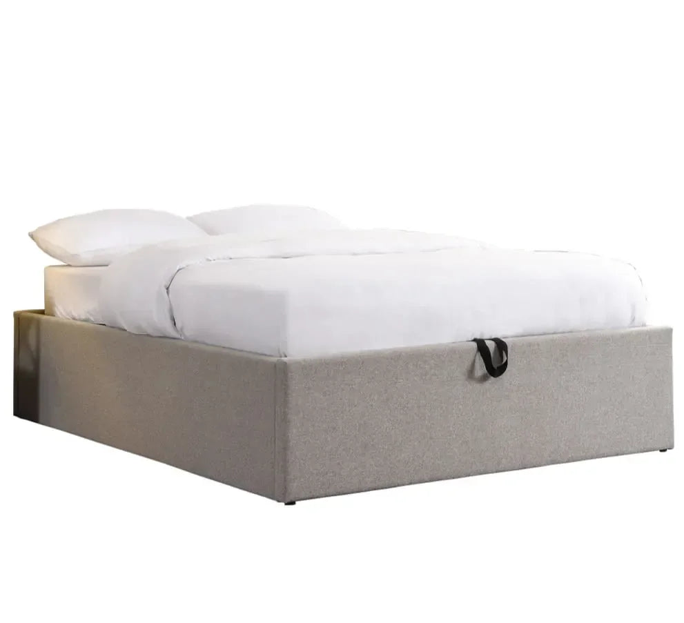 Grey upholstered storage bed with white bedding and black handle, angled front view