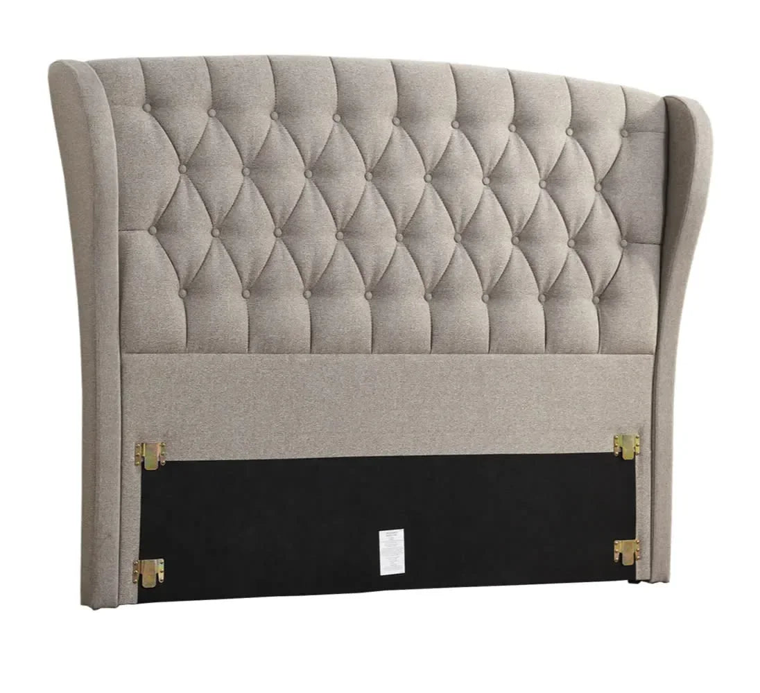 Beige upholstered headboard with diamond tufting and winged sides