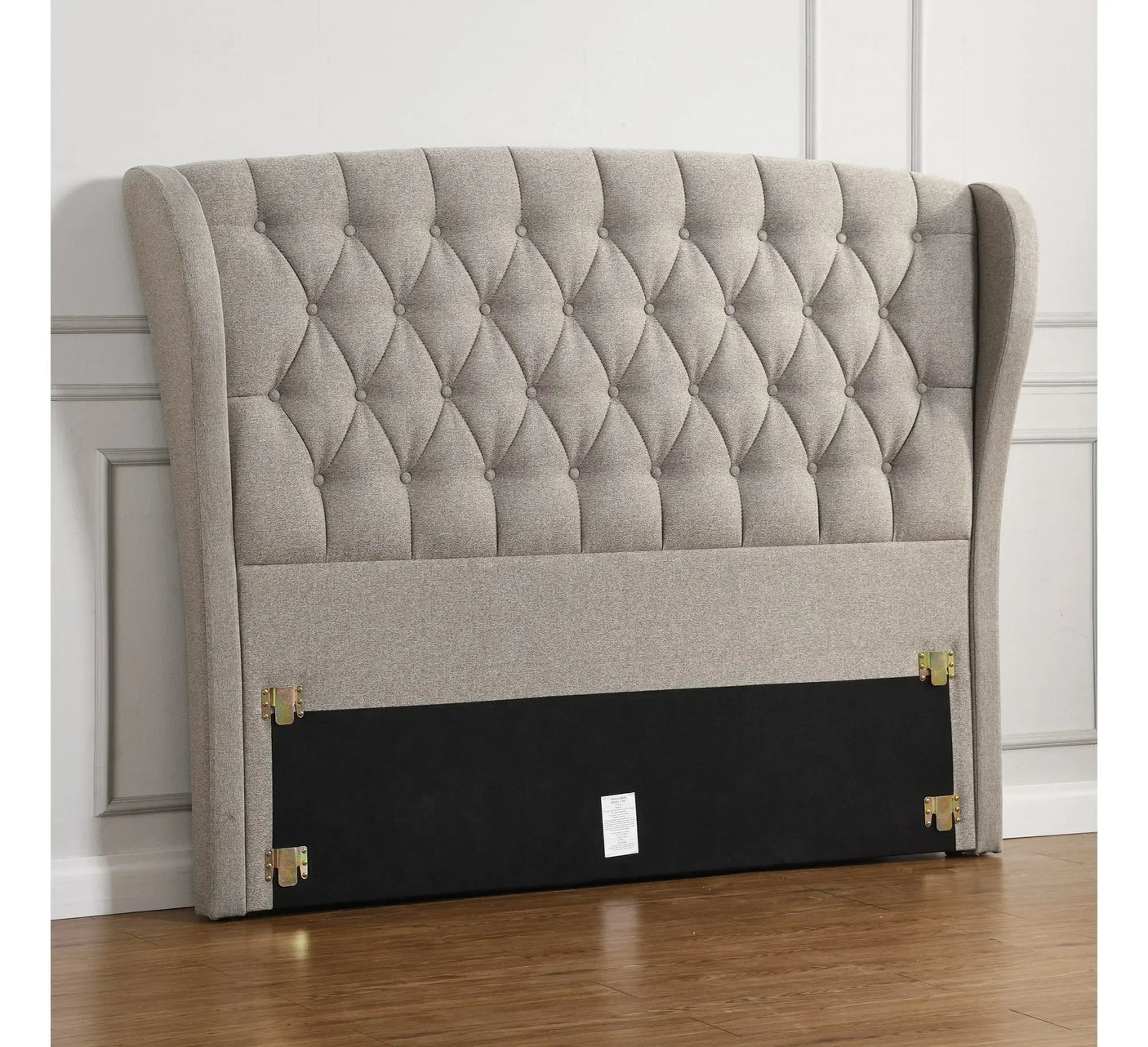 Beige fabric upholstered headboard with diamond button tufting and winged sides