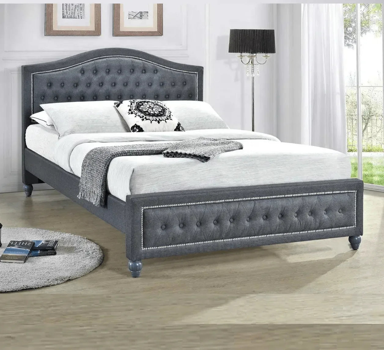 Grey upholstered bed frame with tufted headboard and footboard in modern bedroom
