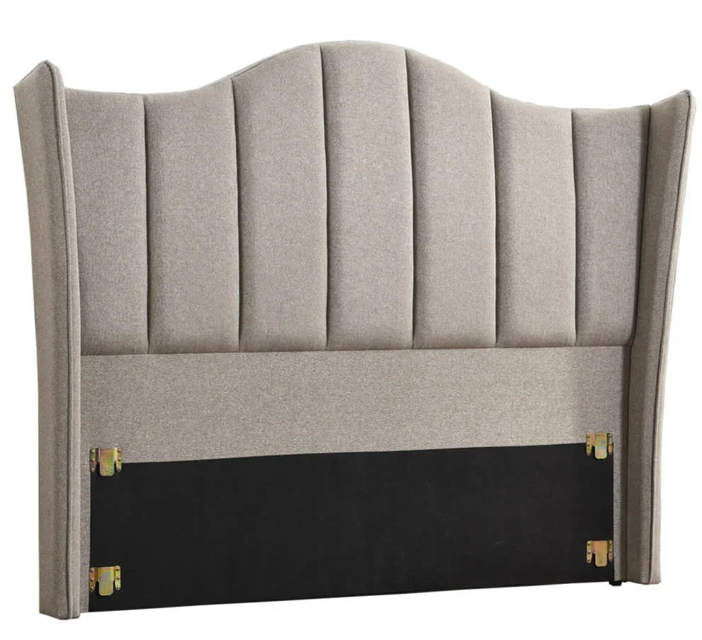 Beige upholstered headboard with vertical stitching and curved top panel