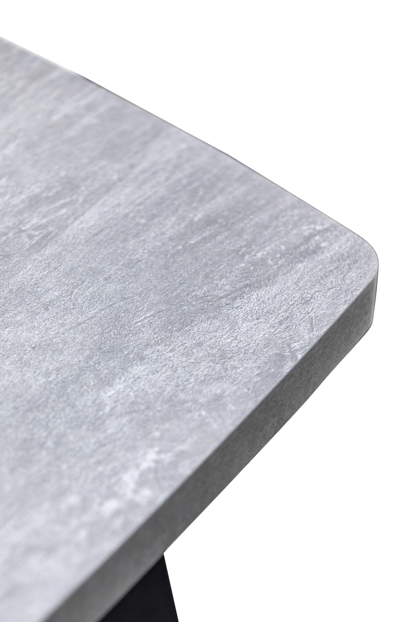 Closeup of grey stone effect dining table corner with textured finish