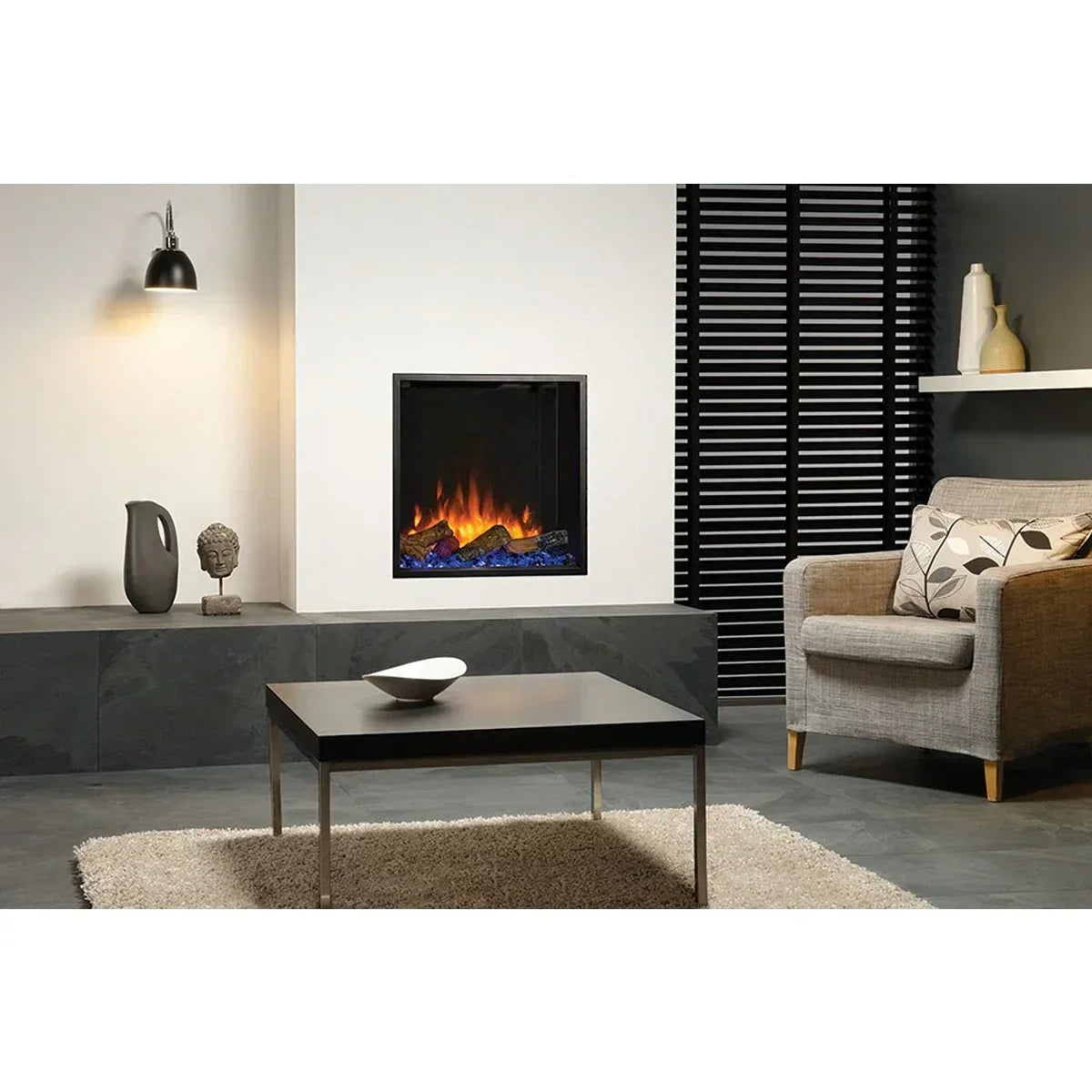 Modern living room with electric fireplace, grey armchair, coffee table and decorative accents