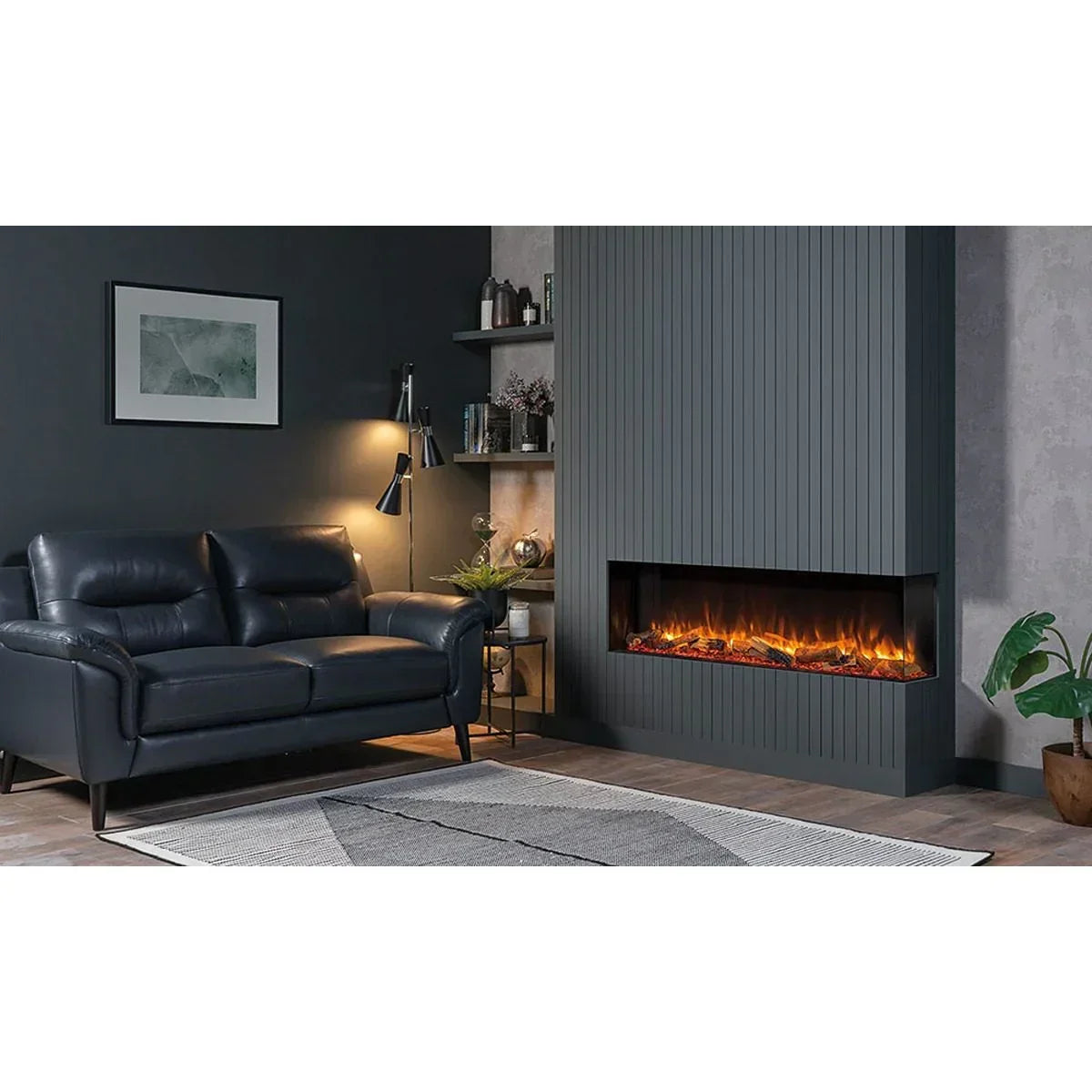Black leather sofa with armrests in modern living room beside wall-mounted electric fireplace