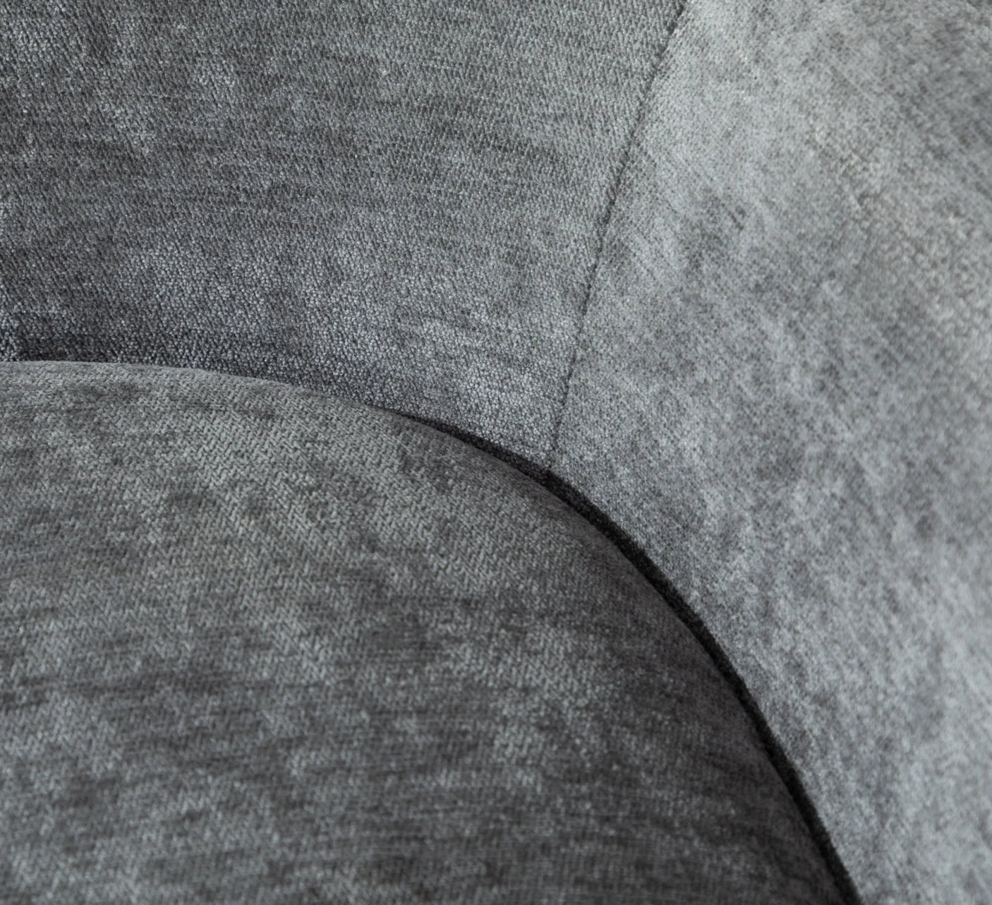 Close-up of grey fabric sofa seat and curved backrest texture