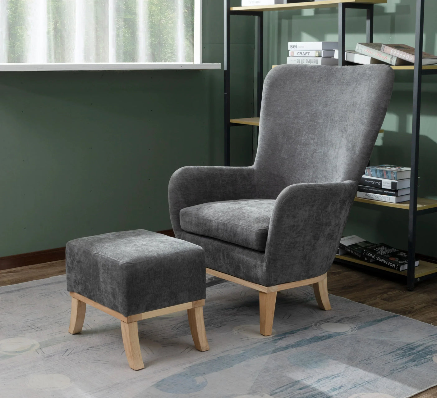 Grey fabric armchair with wooden legs and matching footstool in modern living room