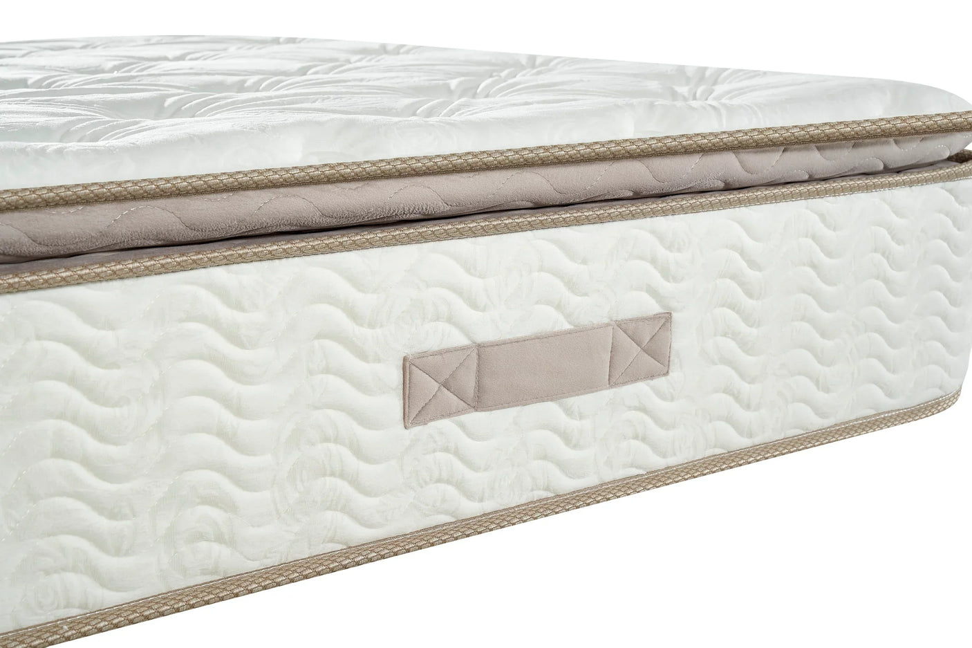 Side view of white mattress with quilted surface, beige trim and fabric handle detail