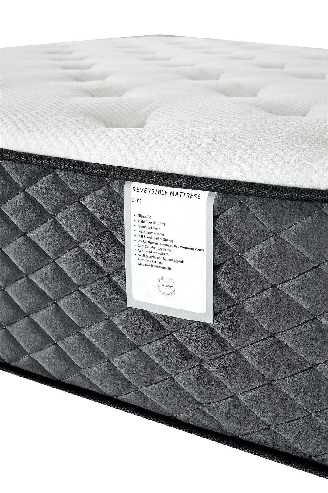 Reversible mattress with quilted dark grey sides and white textured top, close angle view